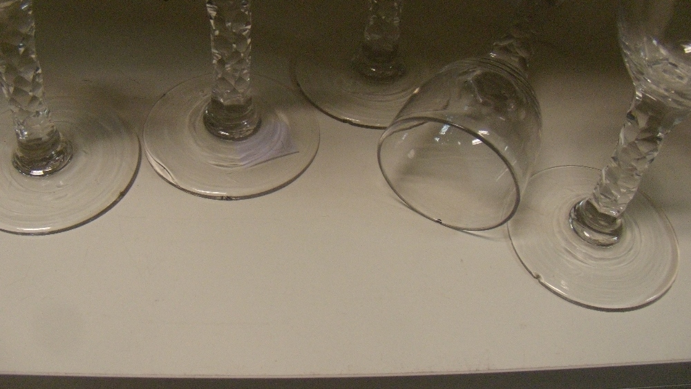 A set of six 18th century wines, each with cylindrical bowls rounding into the facetted stems on - Image 2 of 2