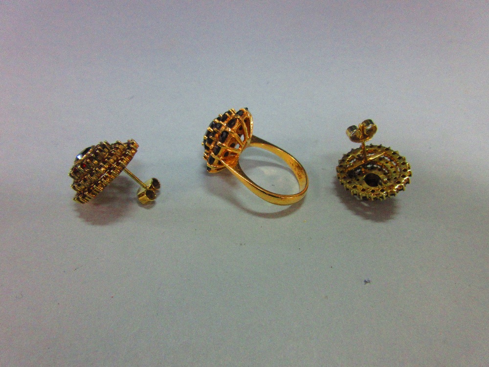 A Bohemian garnet cluster ring and a pair of matched earstuds, the ring with an oval cut pyrope - Image 3 of 4