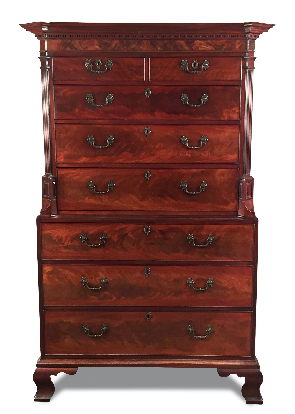 A George III mahogany chest on chest, with a dentil moulded cornice, canted column sides, cast