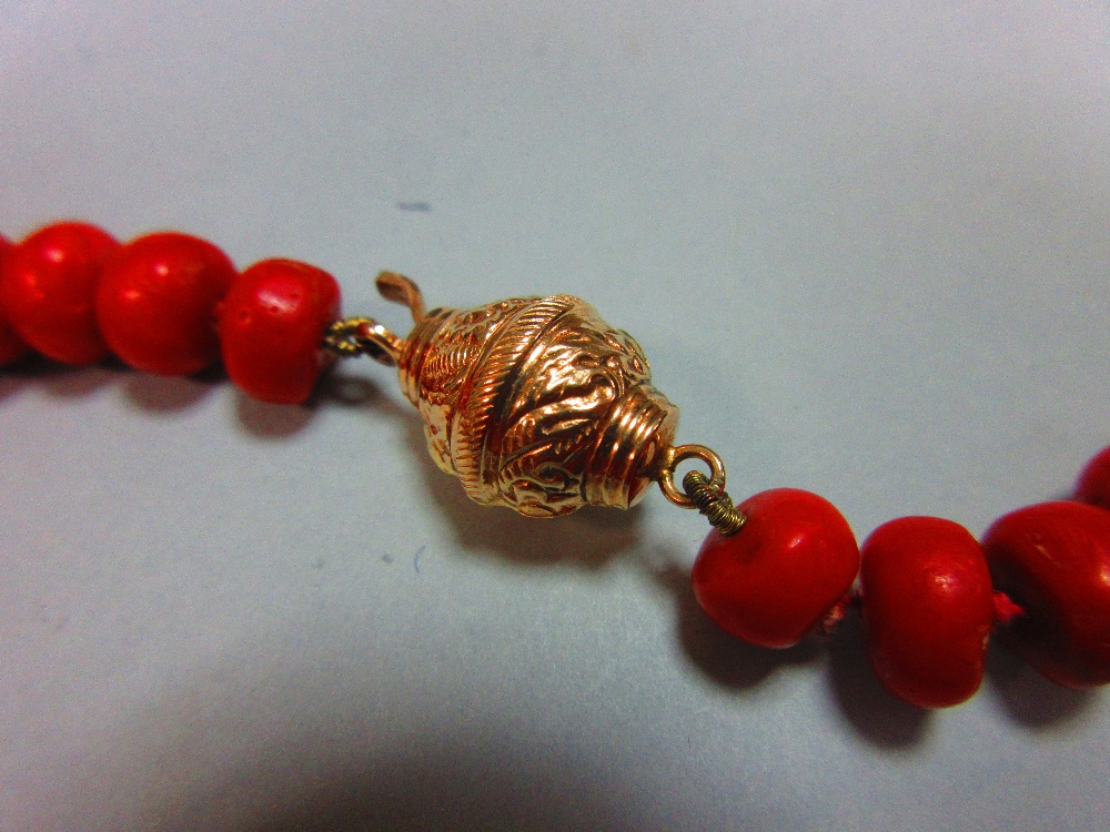 A long red coral bead necklace, the individually-knotted tyre shaped coral beads of approximately - Image 2 of 5