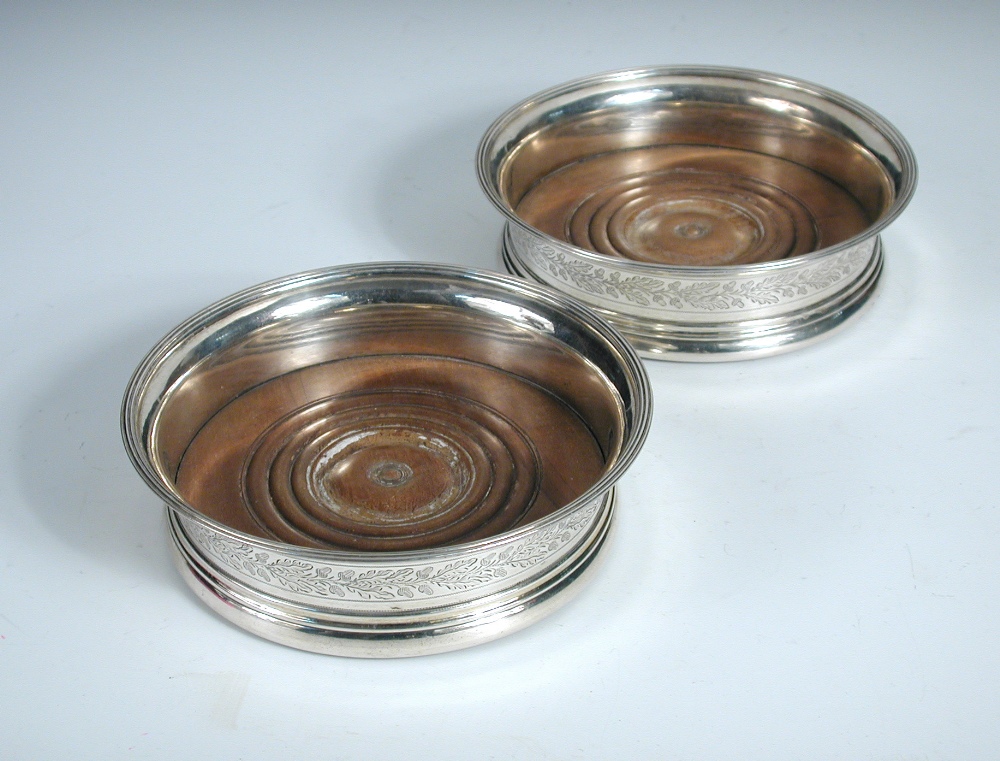 A pair of George III silver wine coasters, by John Emes, London 1803, each circular with moulded