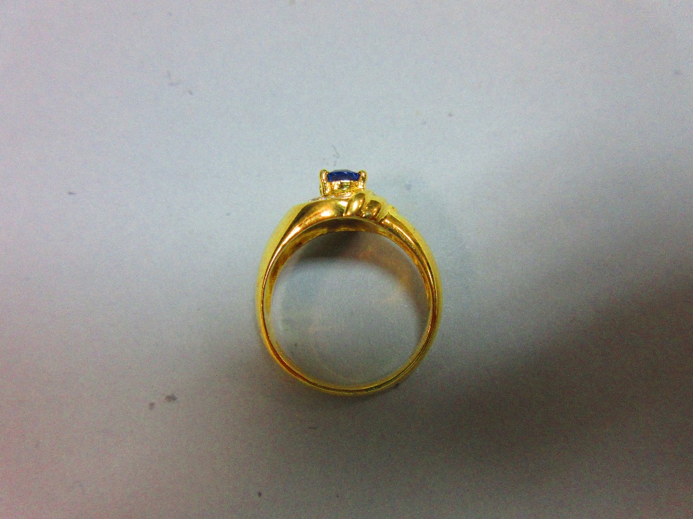 A modern asymmetrical 18ct gold and gemset ring, with a central claw set oval cut vivid blue - Image 5 of 5