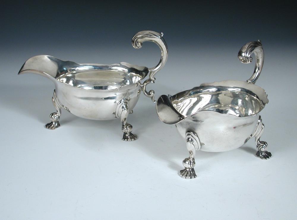 A pair of George II silver sauce boats, by John Swift, London 1741, each of oval shape with cut