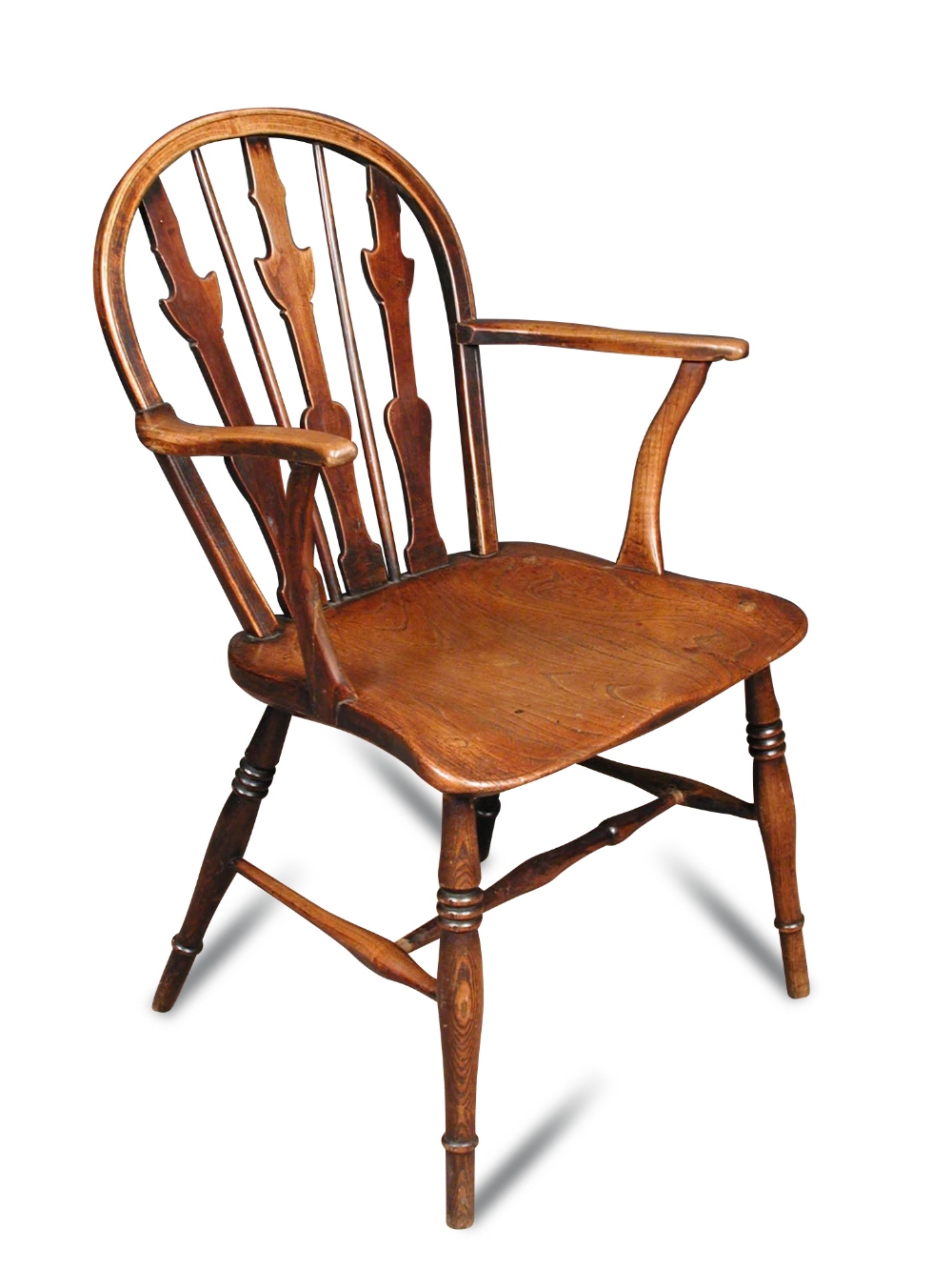 An early 19th century ash and fruitwood Windsor armchair, with fret carved and stick back, on turned