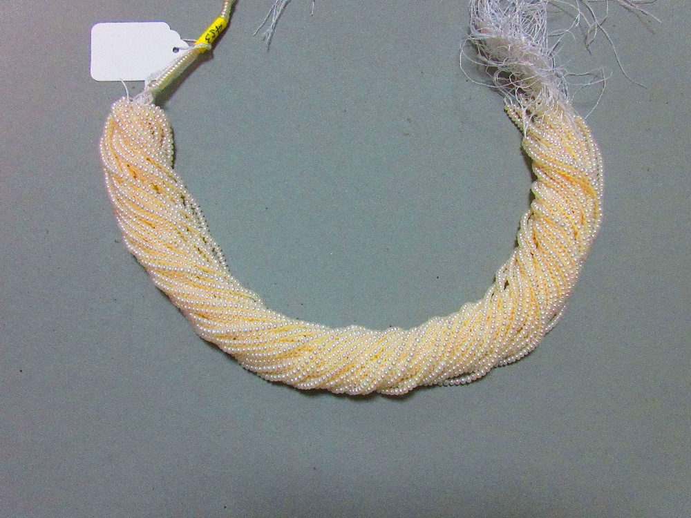 A skein of thirty three strings of 3mm cultured pearls, each string 40.5cm long, the pearls bouton