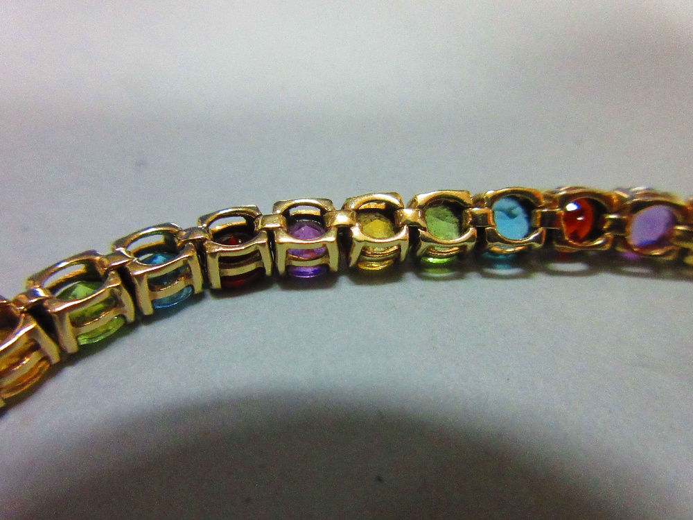 A multi-coloured gem set line bracelet, the uniform round cut gems, to include garnet, blue topaz, - Image 5 of 6
