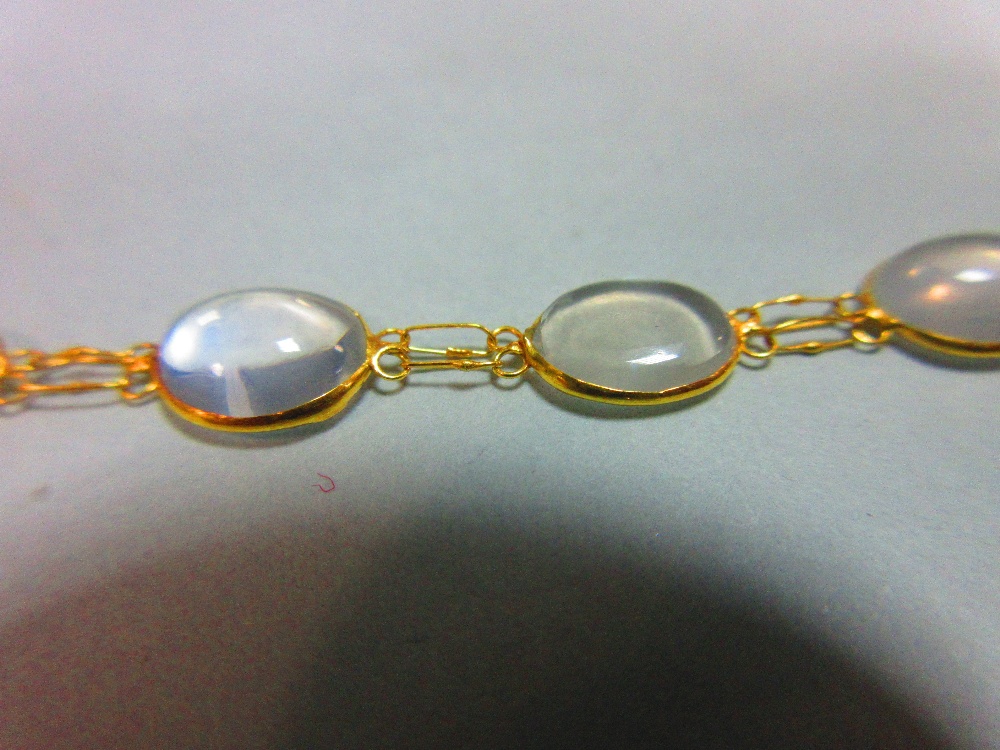 A moonstone necklace, designed as a chain of graduated spectacle set cabochon moonstones joined by - Image 4 of 4