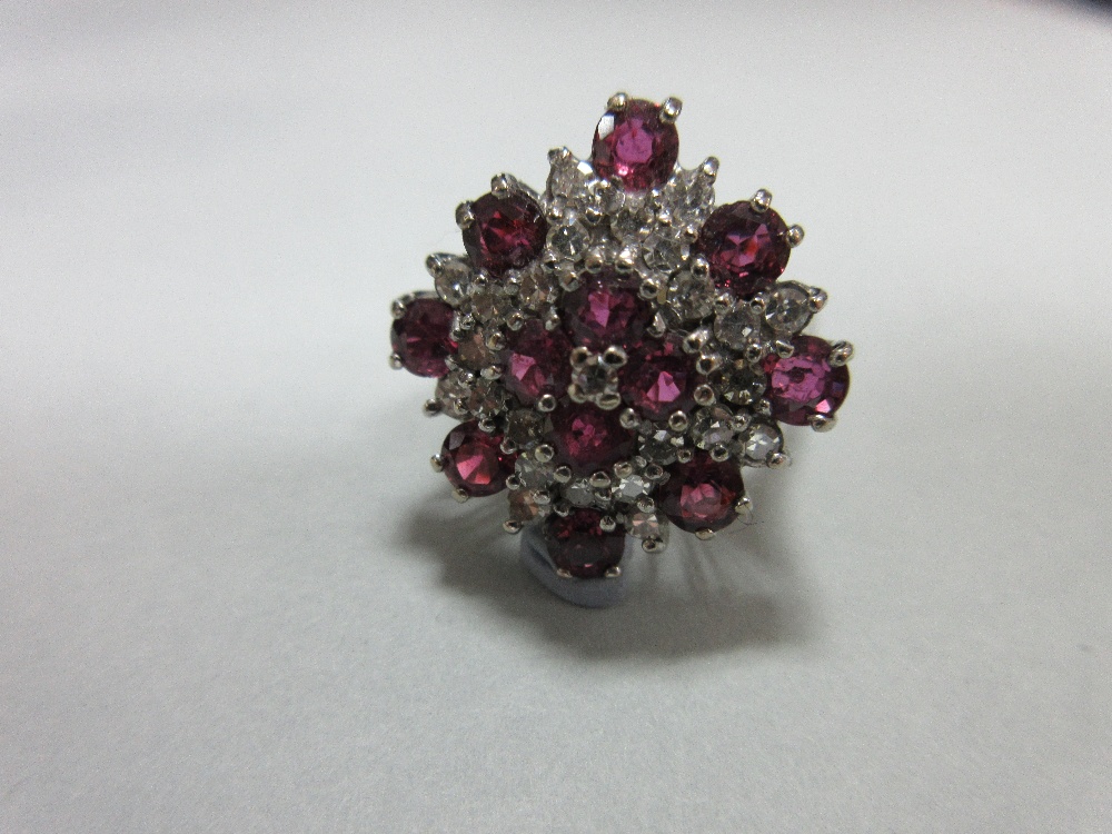 A ruby and diamond cluster ring in 18ct white gold, designed as a densely set diaper with a - Image 3 of 6