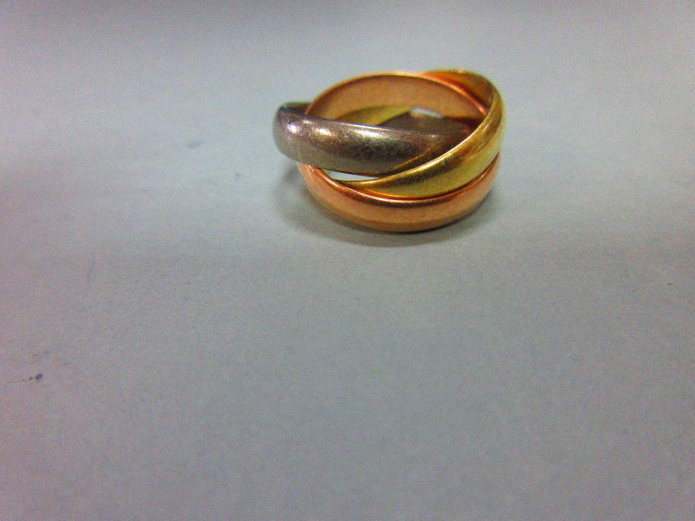 An 18ct three colour gold 'Russian wedding' ring, the three interlocking plain D-section bands,