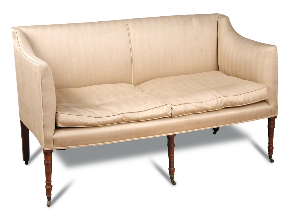 A Regency square back sofa, with loose cushion seat, on six ring turned front legs and casters 90