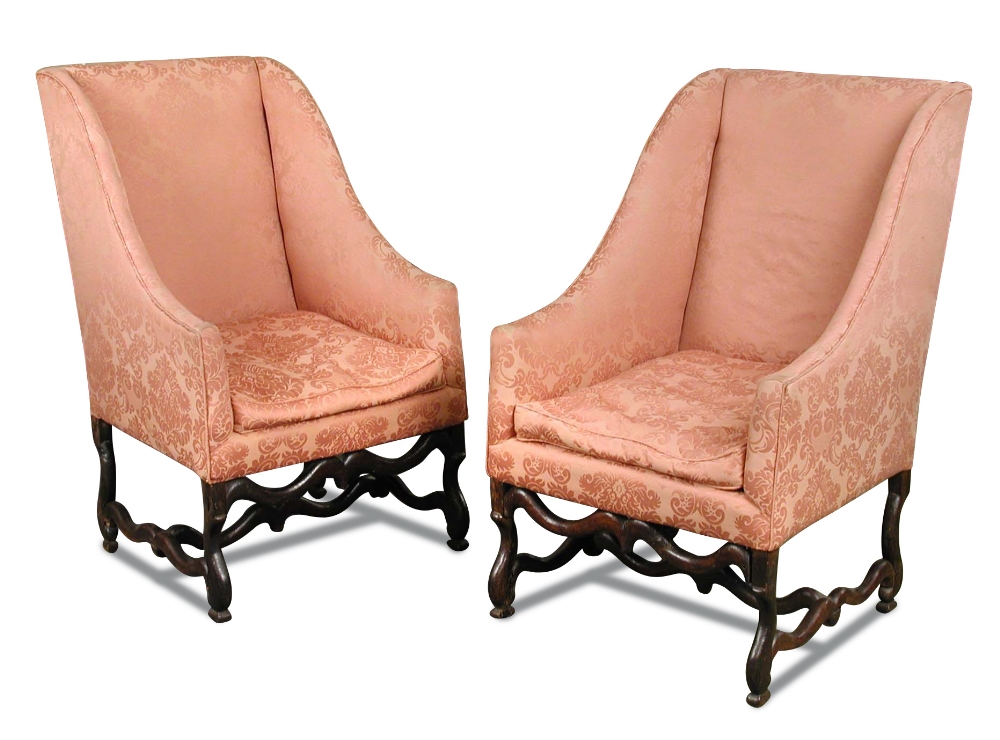 A pair of 17th century oak framed wing back armchairs, in the Dutch manner, upholstered in a pink