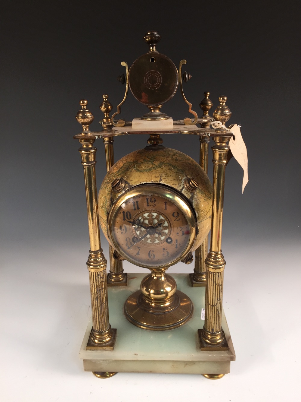 A novelty mantle clock, with movement mounted within a Smith's terrestrial 6 inch globe, to a gilt