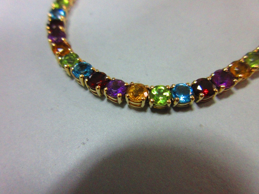 A multi-coloured gem set line bracelet, the uniform round cut gems, to include garnet, blue topaz, - Image 3 of 6