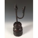 A late 17th/early 18th century rushlight holder on turned wooden base, possibly East Anglian, the