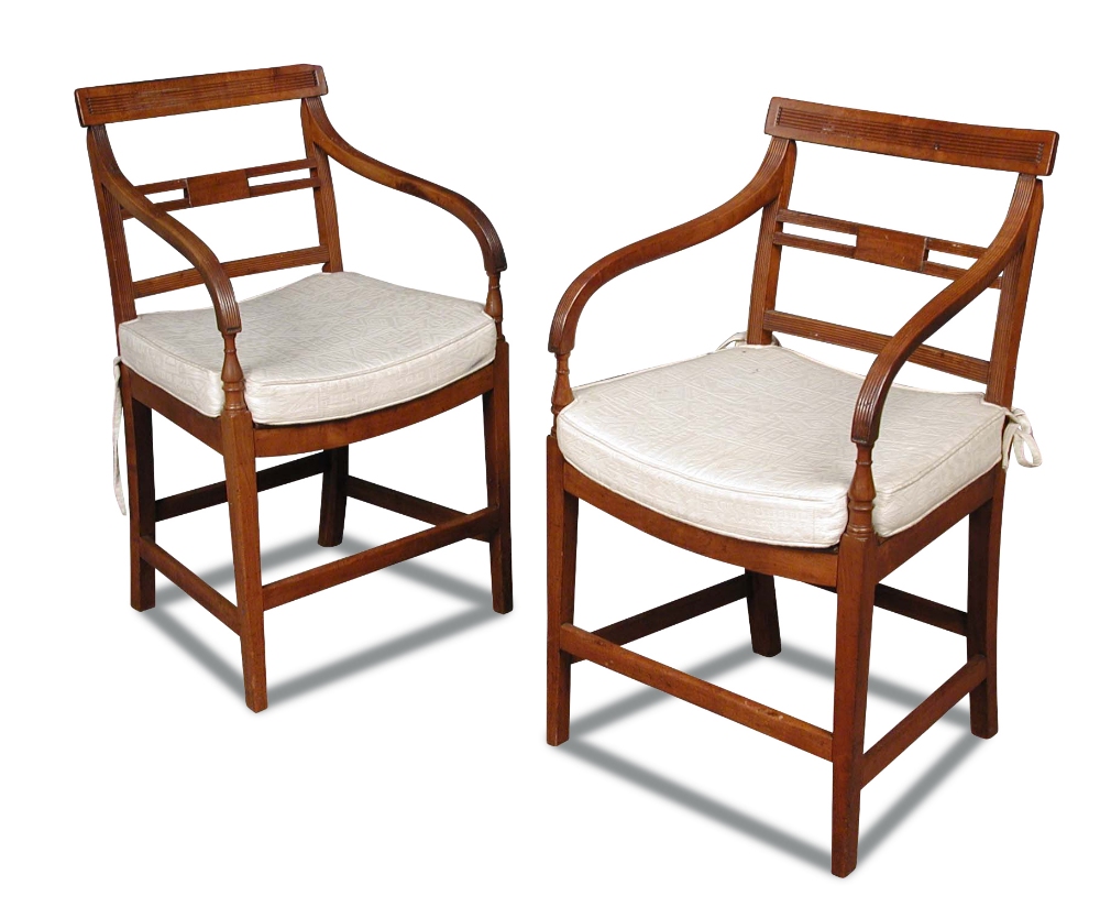 A pair of Regency fruitwood elbow dining chairs, with reeded bar backs and dished panel seats,