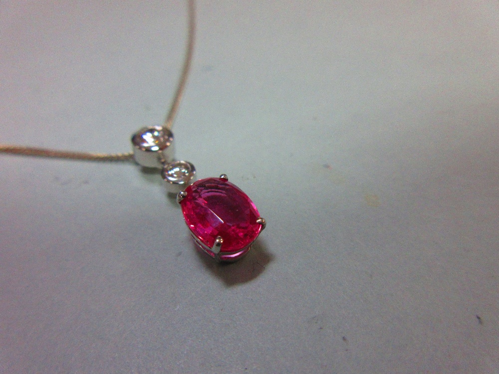 A pink sapphire and diamond pendant set in 18ct white gold, designed as a line of three stones - Image 3 of 6