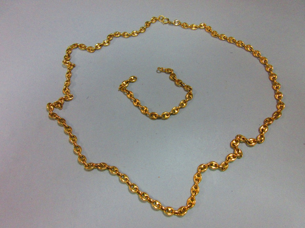 An 18ct gold necklace and bracelet suite, the fancy link chains with Continental assay marks,