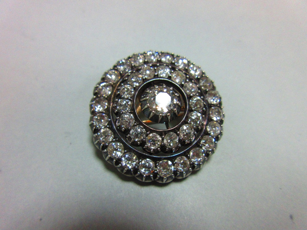 A Victorian diamond target brooch / pendant, the central old round brilliant cut diamond set above