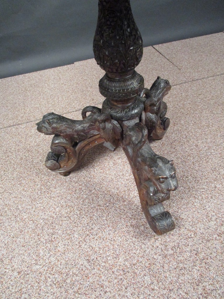 An Indian carved blackwood pedestal table, octagonal top decorated with birds and animals on a - Image 2 of 3