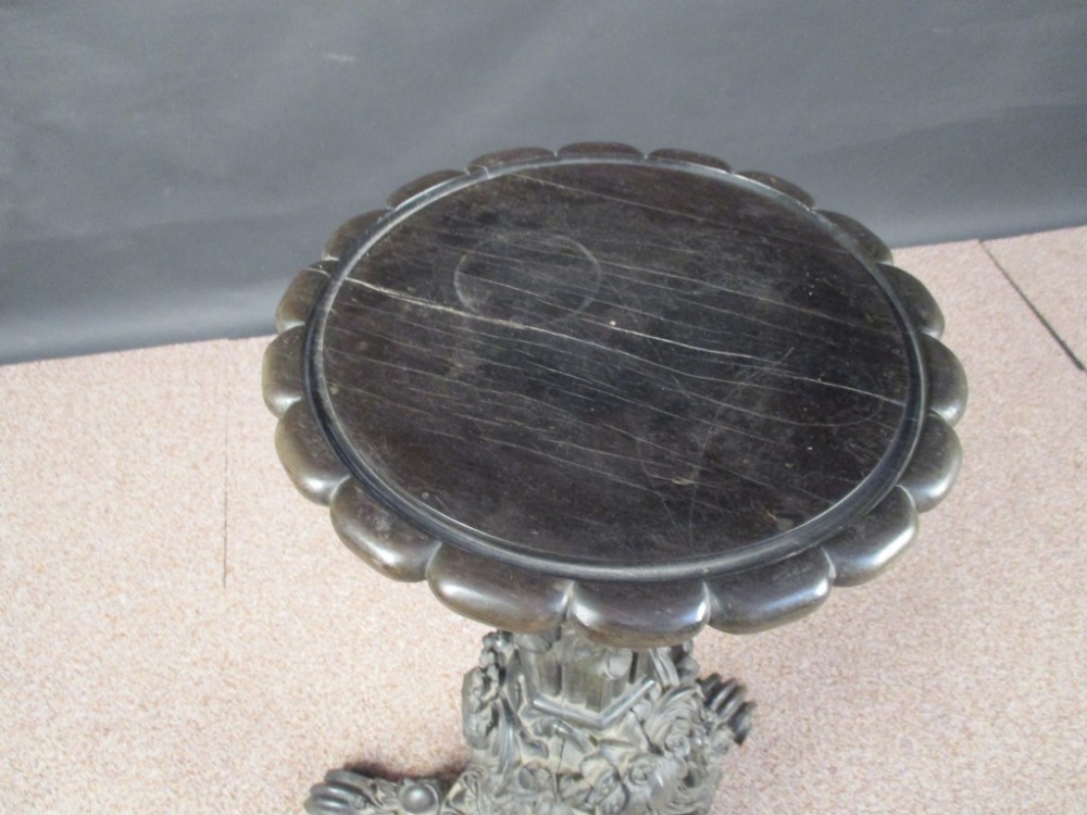 An early 19th century Indian ebony pedestal, profusely carved with leaves, flowers and figure heads, - Image 2 of 3