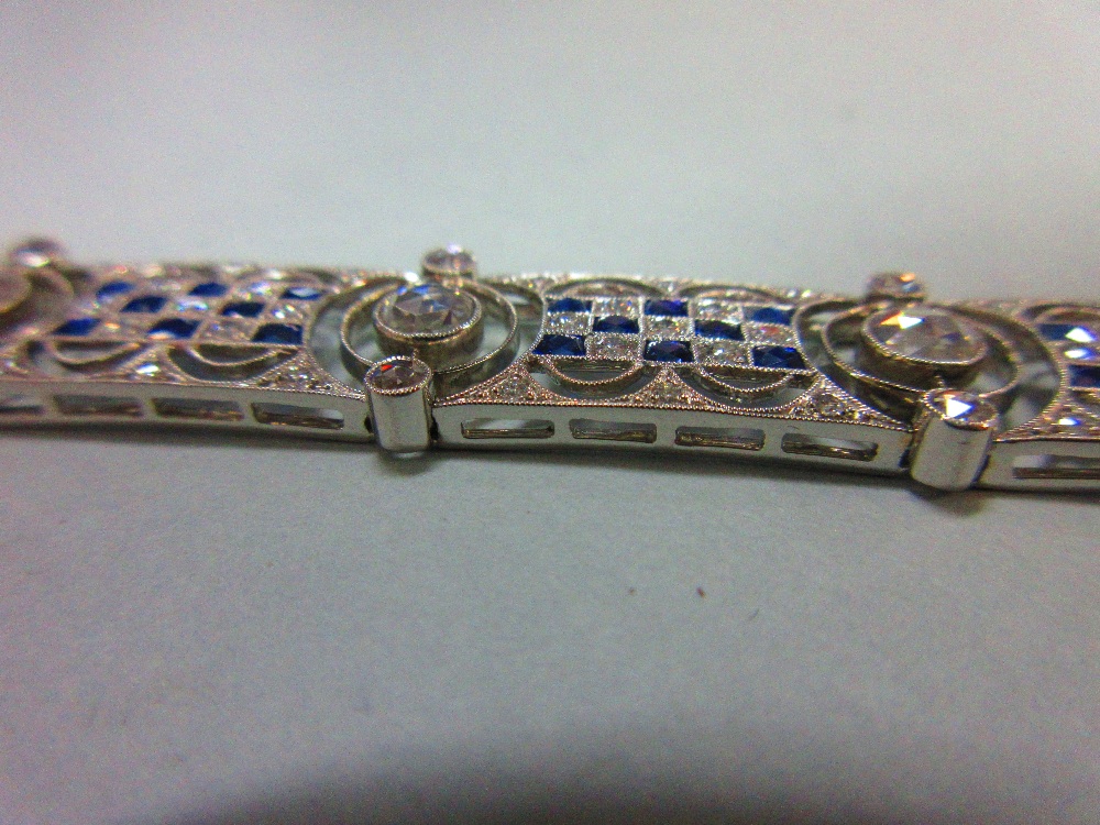 An art deco diamond and sapphire bracelet, designed as nine geometric pierced panels with a - Image 2 of 8