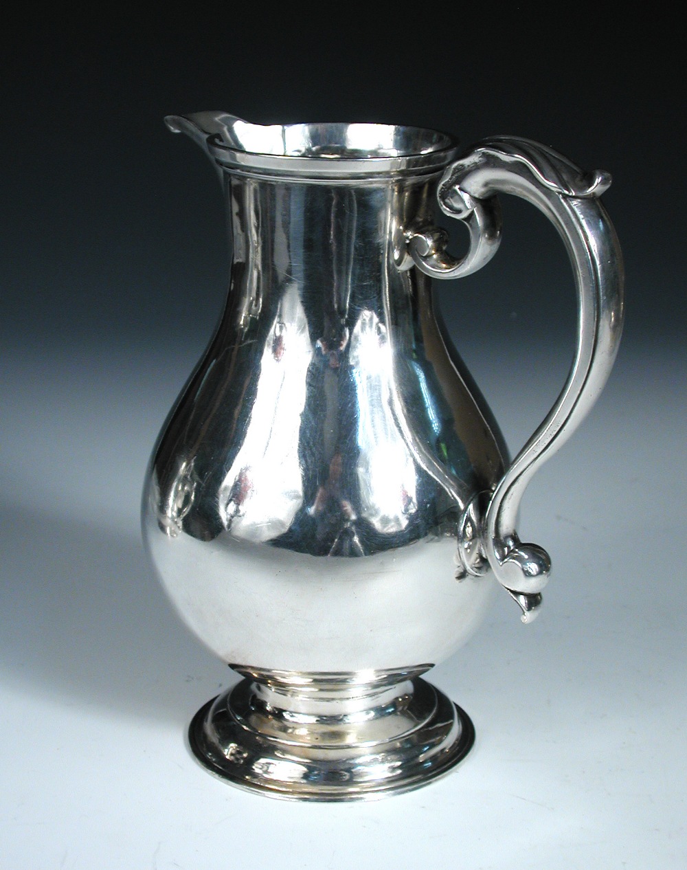 A George II silver ale jug, by Thomas Whipham, London 1775, of plain baluster shape, with leaf
