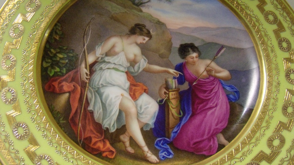 A 19th century Vienna plate painted with Diana the huntress seated on her red cloak by a bluff - Image 2 of 3