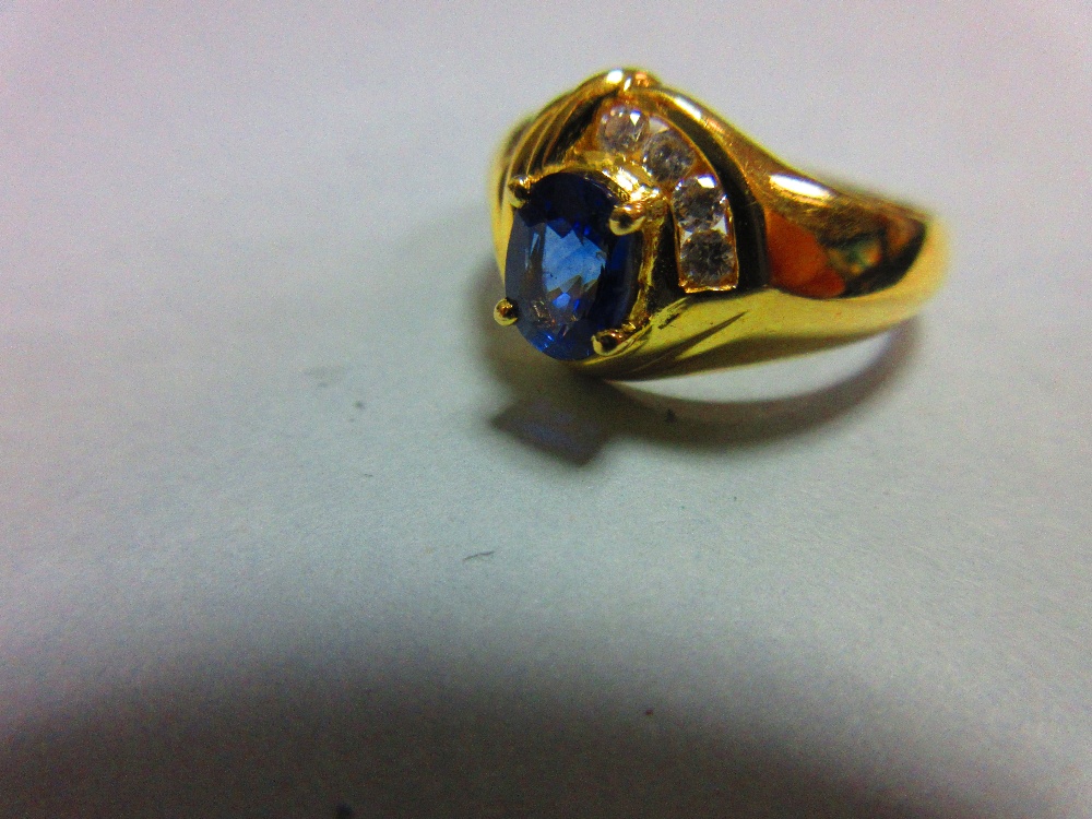 A modern asymmetrical 18ct gold and gemset ring, with a central claw set oval cut vivid blue - Image 2 of 5