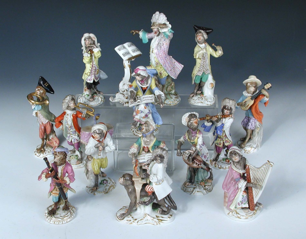 A Meissen fifteen piece monkey band, each of the figures singing or playing an instrument, a drummer