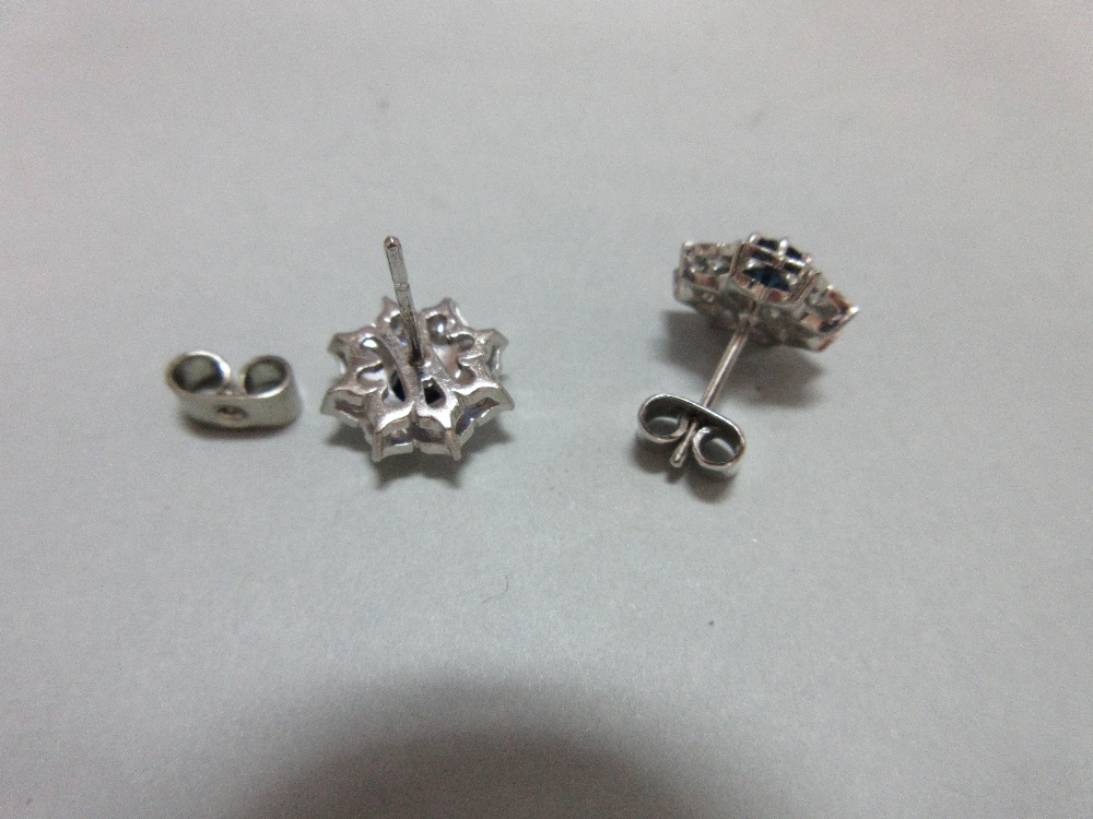 A pair of sapphire and diamond cluster earstuds, each designed as a flowerhead with a round cut - Image 2 of 4