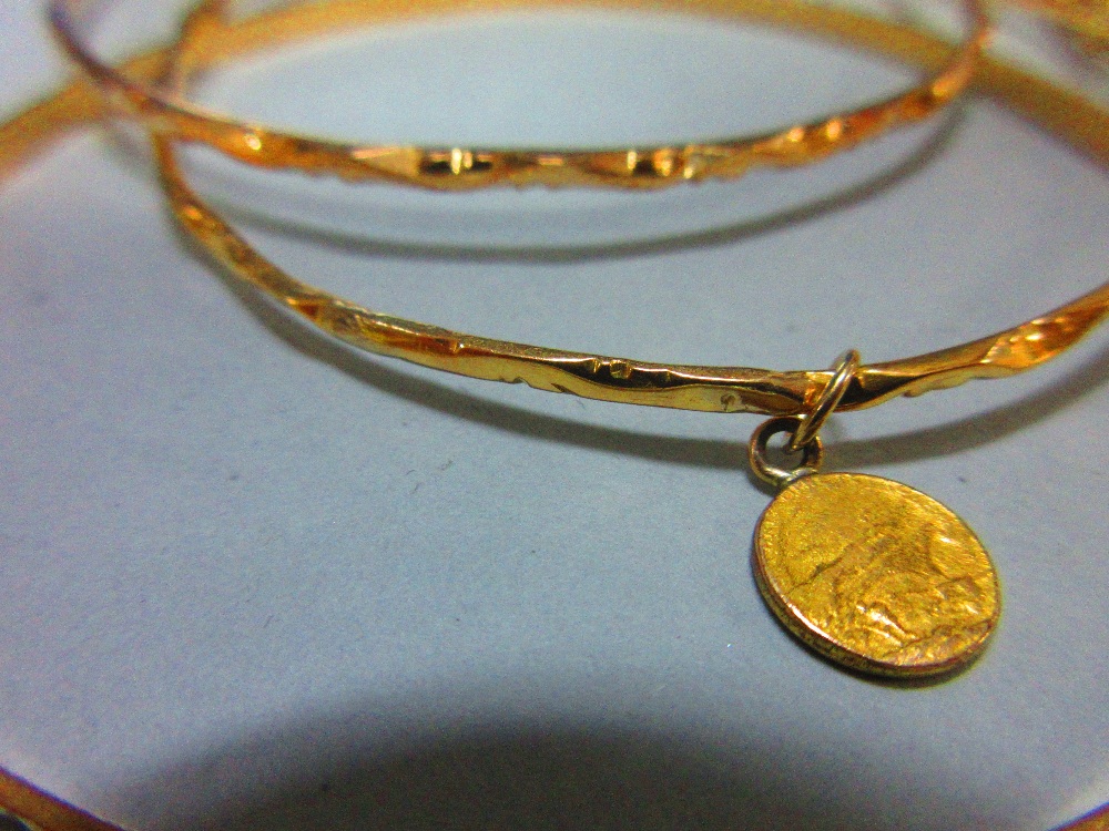 A collection of gold slave bangles, three of hallmarked 22ct gold with faceted diaper patterning, - Image 3 of 5