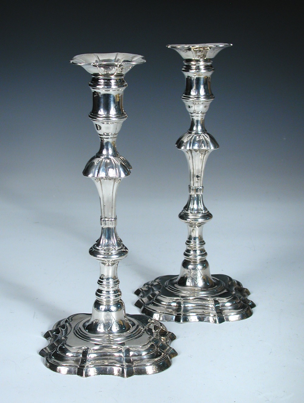 A pair of George III cast silver candlesticks, probably by John Horsley, London 1762, each raised