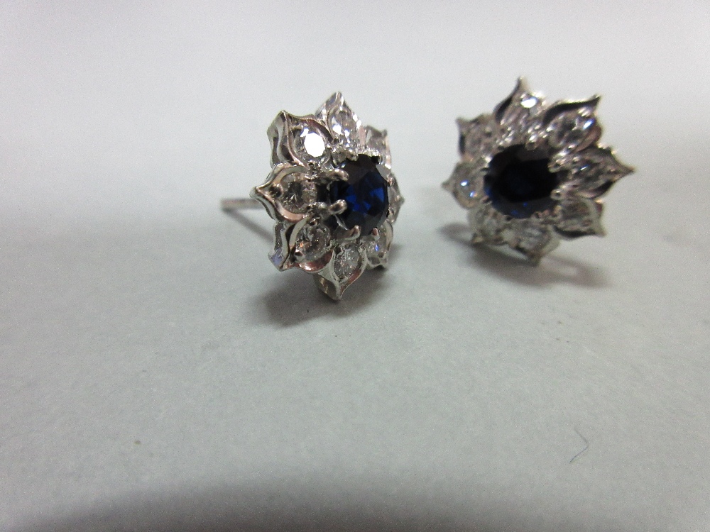A pair of sapphire and diamond cluster earstuds, each designed as a flowerhead with a round cut - Image 4 of 4