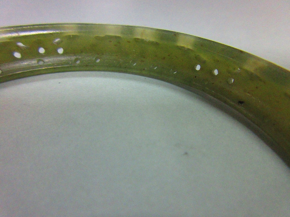 A carved jade bangle, the mottled light green jade of convex profile, pierced and carved with - Image 2 of 5