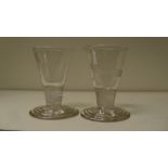 A pair of early 19th century firing glasses, the conical bowls engraved with stags' heads and