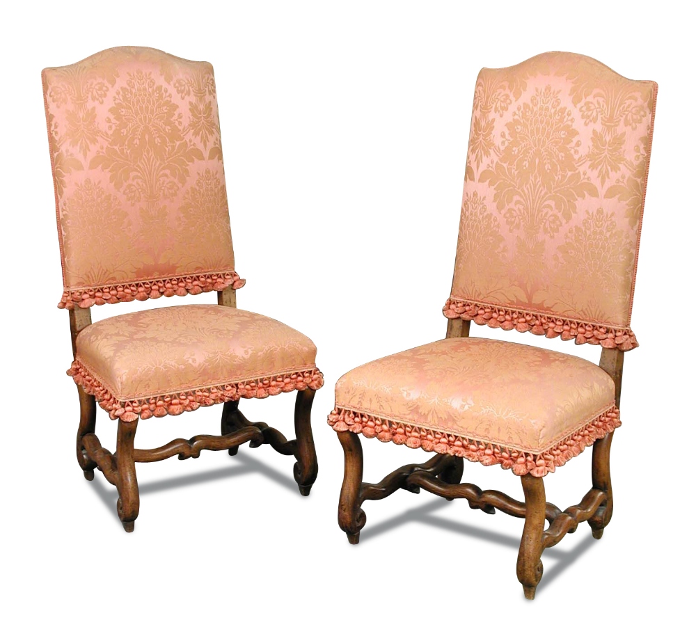 A pair of late 17th century style walnut side chairs, upholstered in pink damask fabric, on scroll