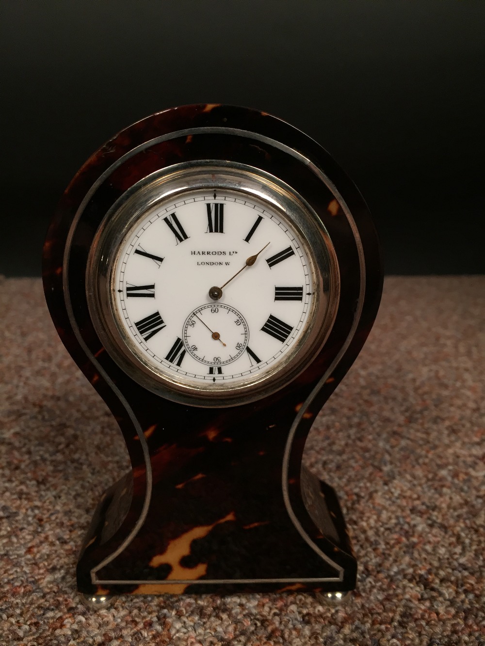 An Edwardian small size tortoiseshell mantle clock, the balloon shape case with 4.5cm (2in) enamel