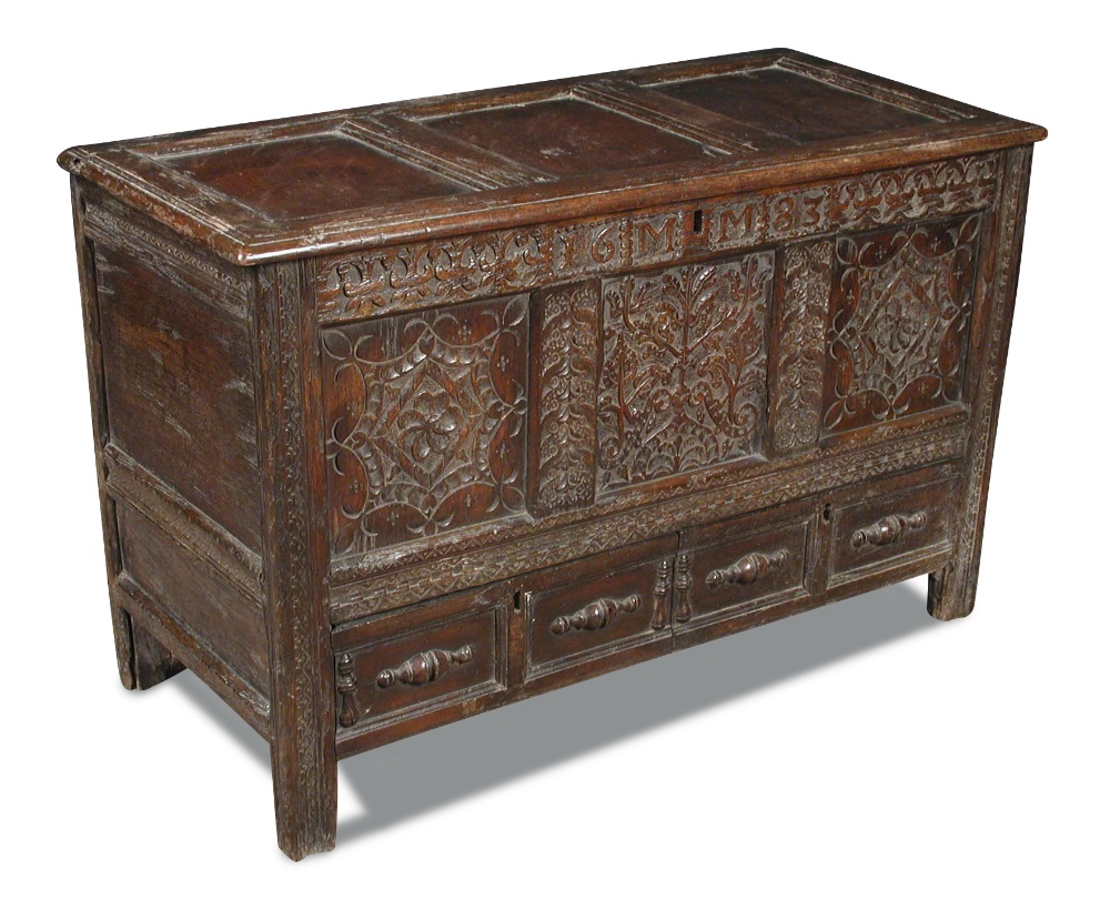 A 17th century panelled oak mule chest, carved with date 1683 and to the front panels, moulded