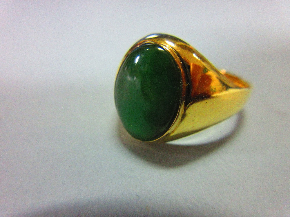 A jade signet form ring, set with a low cabochon polished mid-green jade in rubover setting - Image 2 of 5