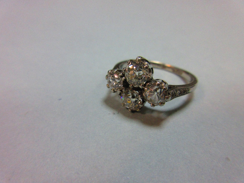 An unusual four stone diamond ring, the old round brilliant cut diamonds claw set in a horizontal - Image 2 of 7