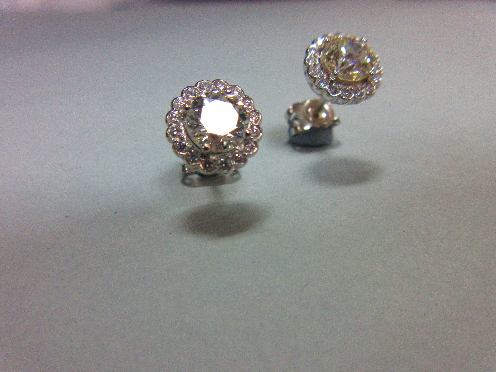 A pair of diamond cluster earstuds, each designed as a four claw set principal round brilliant cut - Image 2 of 3