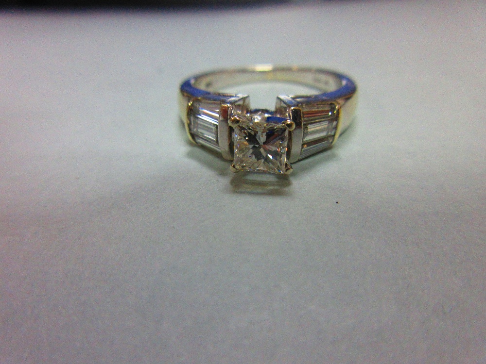 A contemporary princess cut diamond ring, the principal diamond four claw set to flying shoulders - Image 5 of 6