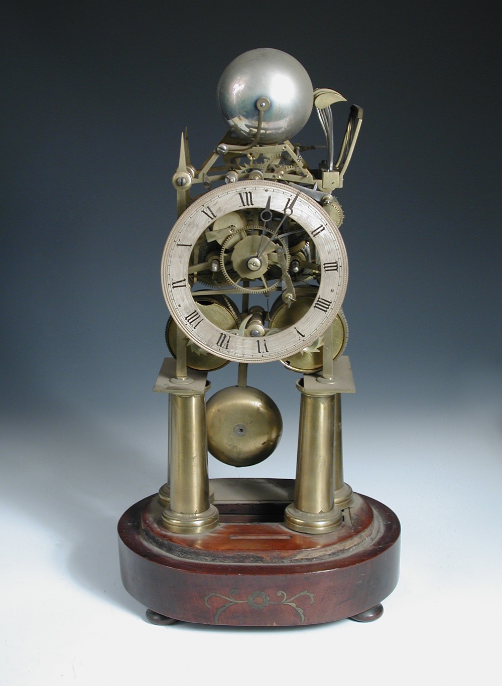 A Victorian brass bell chiming skeleton clock, the four tapering column legs supporting the twin