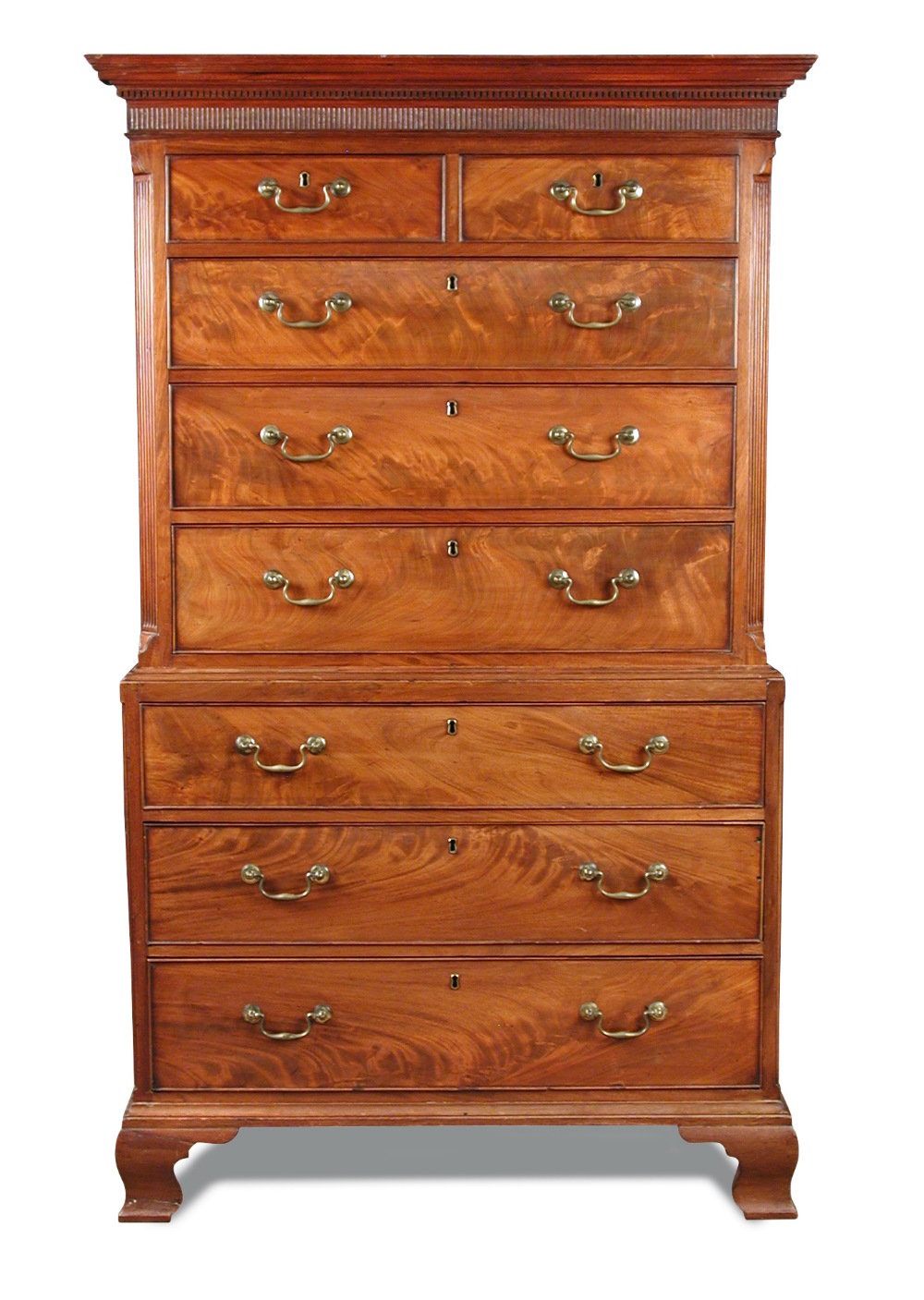 A George III mahogany chest on chest, with dentil moulded cornice, canted reeded sides, fitted two