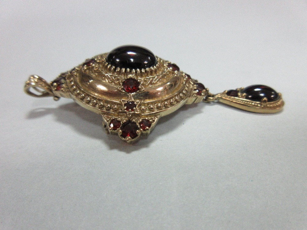 A gold and garnet Holbeinesque pendant / brooch, of oval tiered form, set to the cardinal points - Image 2 of 6