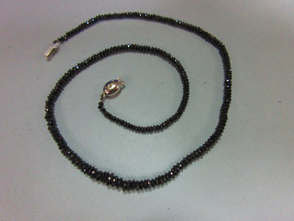 A black diamond bead necklace, the graduated 2.5 - 5.3mm diameter faceted black diamond beads,