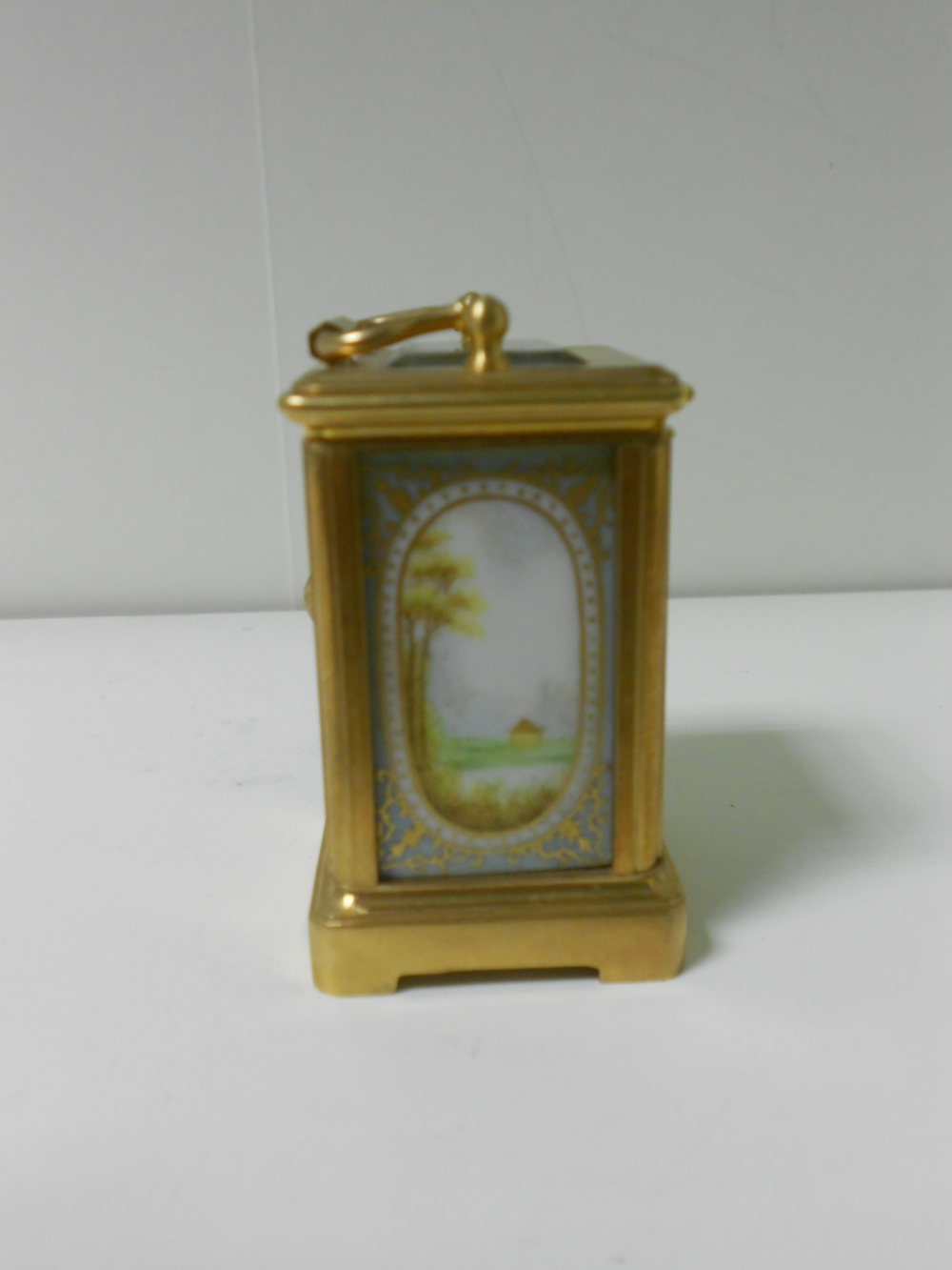 A miniature French porcelain panel gilt brass carriage timepiece, with gilt decorated pale blue - Image 4 of 5