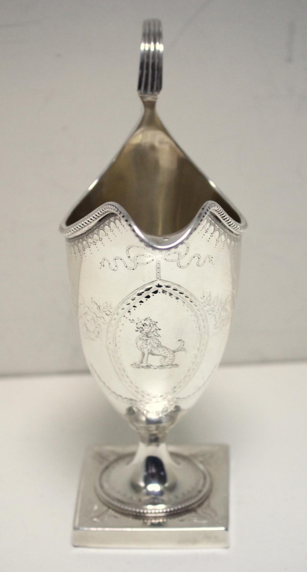 A George III silver creamer, by Hester Bateman, London 1786, of helmet shape, the body engraved with - Image 2 of 4