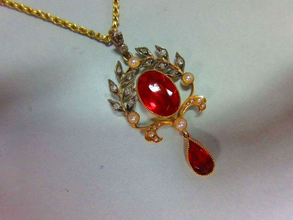 A belle époque fire opal, diamond and seed pearl pendant with chain, the oval cut fire opal collet