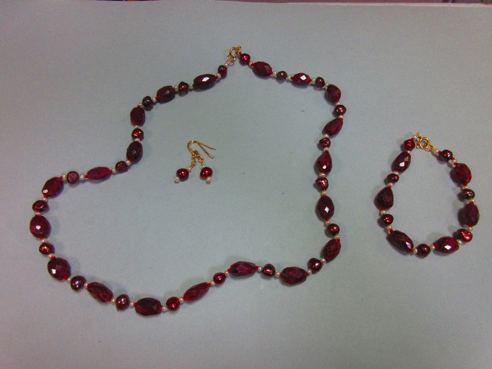 A ruby and pearl suite, the necklace and bracelet, which may be worn individually or continuously,